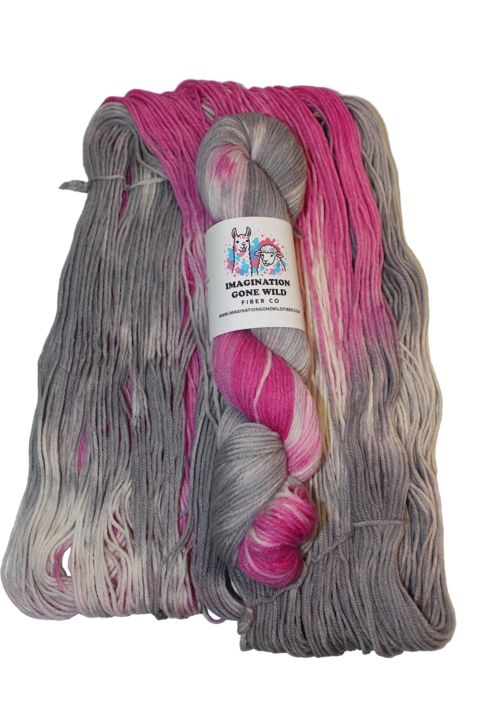 A folded skein of variegated yarn with pink, gray, and white color-changing sections, secured with a white paper label that reads 'Misty Mountain Co. Variegated Yarn'.