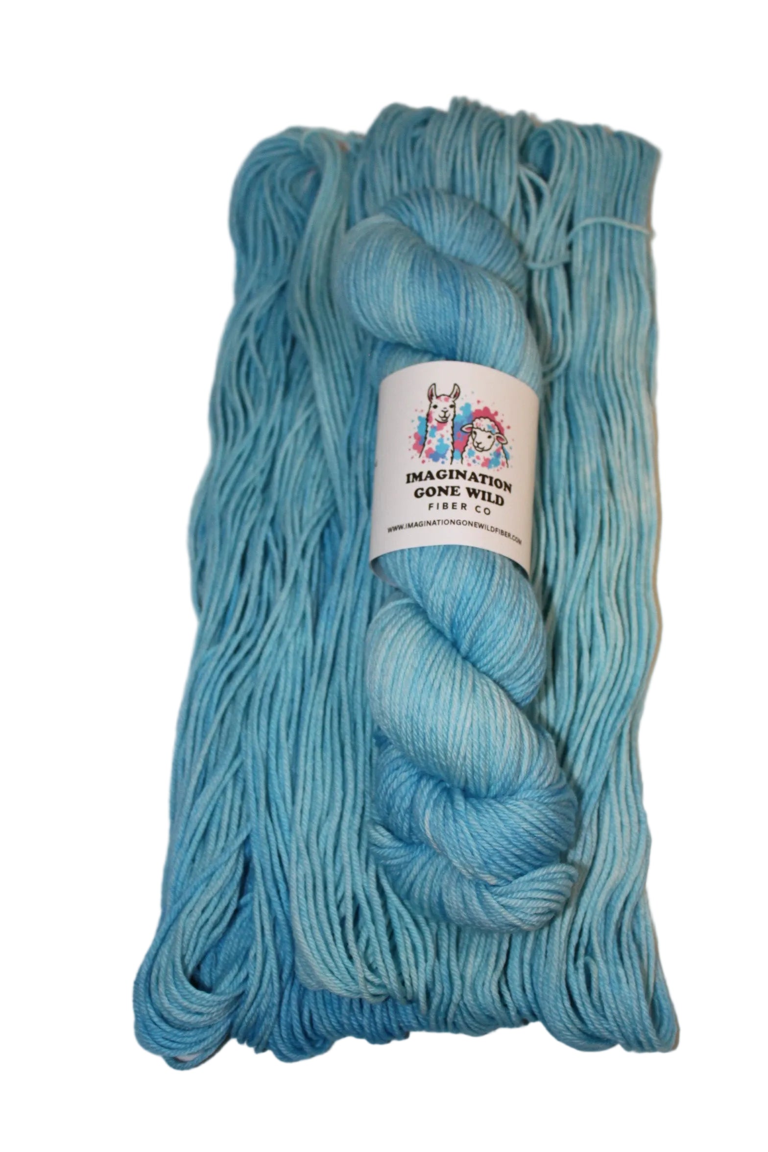 A skein of light blue yarn with a white paper label in the center, photographed against a plain light gray background.